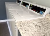 Thumbnail 15 of 20 - A white dishwasher is placed next to a granite countertop.