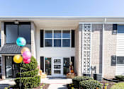 Thumbnail 6 of 22 - A building with a balloon decoration in front.