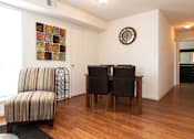 Thumbnail 9 of 22 - A room with a brown chair and a brown table.