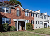 Thumbnail 17 of 19 - A row of red brick houses with white trim and windows.
