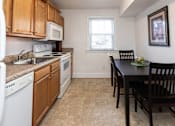 Thumbnail 4 of 19 - A kitchen with a table and chairs.
