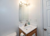 Thumbnail 13 of 19 - A white sink with a mirror above it.