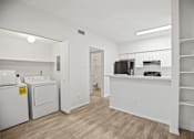 Thumbnail 14 of 29 - A white laundry room with a washer and dryer.