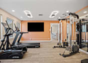 Thumbnail 4 of 29 - A gym with treadmills and exercise equipment.
