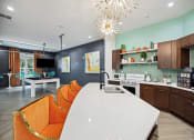Thumbnail 6 of 57 - a kitchen and dining room with a white table and orange chairs at Shellbrook, Raleigh