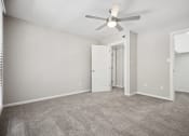 Thumbnail 49 of 57 - an empty living room with a ceiling fan and a closet at Shellbrook, Raleigh, North Carolina
