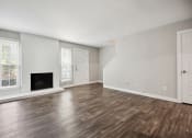 Thumbnail 35 of 57 - the living room of an apartment with a fireplace and wooden floors at Shellbrook, Raleigh, 27609