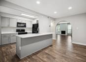 Thumbnail 36 of 57 - an open kitchen and living room with white cabinets and stainless steel appliances at Shellbrook, Raleigh, NC