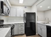Thumbnail 37 of 57 - an empty kitchen with white cabinets and black appliances at Shellbrook, Raleigh, North Carolina