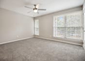 Thumbnail 39 of 57 - an empty living room with a large window and a ceiling fan at Shellbrook, Raleigh, North Carolina