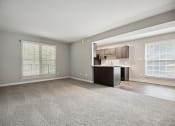 Thumbnail 44 of 57 - an empty living room with a kitchen in the corner at Shellbrook, North Carolina