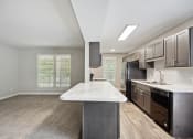 Thumbnail 41 of 57 - a kitchen with black appliances and a marble counter top at Shellbrook, Raleigh, 27609