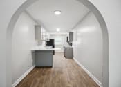 Thumbnail 53 of 57 - a kitchen and living room with white walls and wood floors at Shellbrook, Raleigh, NC
