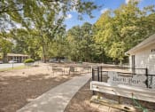 Thumbnail 24 of 57 - a park bench in front of a park with trees at Shellbrook, Raleigh, North Carolina