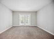 Thumbnail 45 of 57 - an empty living room with white walls and a door to a balcony at Shellbrook, Raleigh, NC, 27609