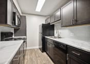Thumbnail 46 of 57 - a kitchen with marble counter tops and black appliances at Shellbrook, Raleigh, 27609
