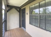 Thumbnail 39 of 40 - a front porch with a door and windows