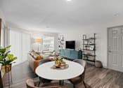 Thumbnail 4 of 29 - A living room with a white table and brown chairs.