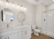 Thumbnail 17 of 47 - Modern designed bathroom interiors featuring custom vanities and stand-up shower options at Centro at Pine Nash, Wilson, NC
