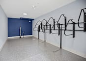 Thumbnail 19 of 29 - A gym with a row of black pull up bars.