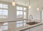 Thumbnail 11 of 42 - a kitchen with granite counter tops and a sink at The Bella at Westchester, Midlothian, 23113