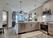 Thumbnail 1 of 38 - an open kitchen with stainless steel appliances and white counter tops at Aura Stonebridge, Richmond, VA