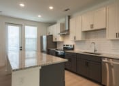 Thumbnail 17 of 81 - a kitchen with white cabinets and a granite counter top at Ainsworth, Richmond, 23228