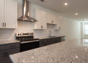Thumbnail 20 of 81 - a kitchen with white cabinets and black appliances at Ainsworth, Virginia,3228