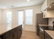 Thumbnail 21 of 81 - a kitchen with white walls and a granite counter top at Ainsworth, Richmond