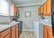 Thumbnail 7 of 15 - a kitchen with a counter top and a window