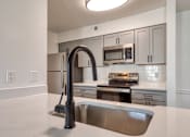Thumbnail 6 of 56 - A modern kitchen with a stainless steel sink and appliances.