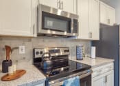 Thumbnail 29 of 53 - an updated kitchen with stainless steel appliances and granite counter topsat The View at Blue Ridge Commons Apartments, Roanoke