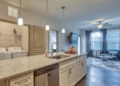 Thumbnail 28 of 53 - a kitchen with a granite counter top and a sinkat Blue Ridge Commons Apartments, Roanoke