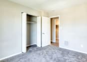 Thumbnail 46 of 52 - an empty bedroom with a closet and a door open at Bayville Apartments, Virginia Beach, Virginia