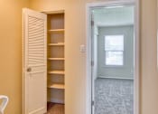 Thumbnail 16 of 26 - A white door is open to a room with a window and a sink.