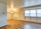Thumbnail 19 of 24 - an empty living room with wood floors and windows at Gates of West Bay in Norfolk, Virginia 23503