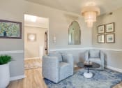 Thumbnail 8 of 15 - a living room with two chairs and a table