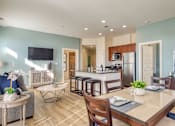 Thumbnail 72 of 88 - A modern kitchen with a dining table set for two.