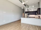 Thumbnail 80 of 88 - A kitchen area with a stainless steel refrigerator and a countertop.