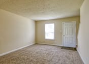Thumbnail 15 of 26 - A room with a carpeted floor and a white door.