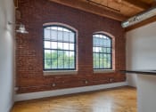 Thumbnail 11 of 46 - an empty room with two large windows at The Hudson, Richmond, VA, 23224