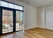 Thumbnail 5 of 29 - A room with a sliding glass door leading to a balcony at Aviator Lofts, Newport News, Virginia 23602