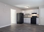 Thumbnail 9 of 31 - A kitchen with black appliances and white cabinets.