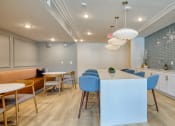 Thumbnail 40 of 42 - a kitchen and dining room with blue chairs and a white counter at The Bella at Westchester, Midlothian, 23113