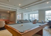 Thumbnail 32 of 42 - a community room with a pool table and a tv at The Bella at Westchester, Midlothian, VA