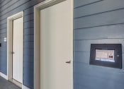 Thumbnail 7 of 53 - a white door to a blue building with an automated door sensor on the sideat Blue Ridge Commons Apartments, Roanoke, 24017