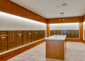 Thumbnail 44 of 81 - a locker room with wooden lockers and a counter in the middle at Ainsworth, Richmond