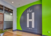 Thumbnail 33 of 46 - a large green and grey logo on a grey wall in an office at The Hudson, Richmond