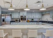 Thumbnail 23 of 33 - A kitchen with a white table and chairs.