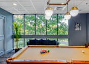 Thumbnail 25 of 33 - A pool table with a green, orange, and red ball on it.